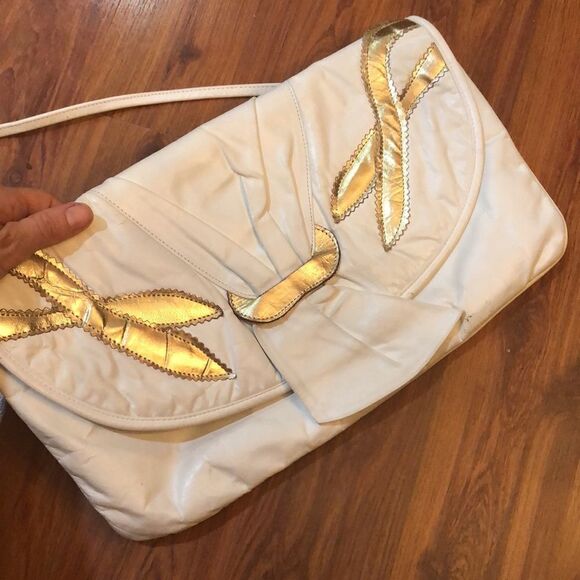 Vintage White and gold leather clutch purse with straps.